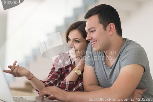 Image of happy young couple buying online