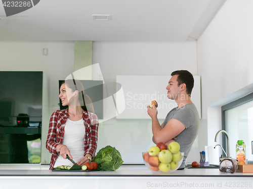 Image of Young handsome couple in the kitchen