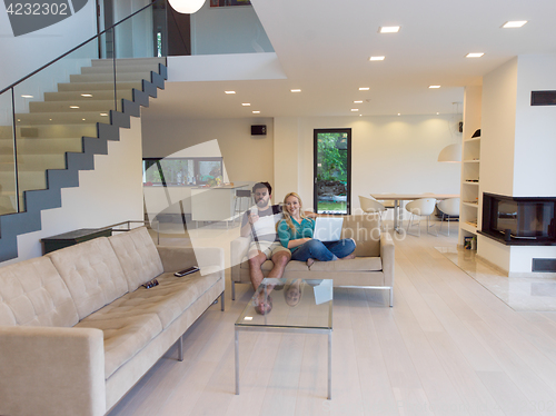 Image of young happy couple relaxes in the living room