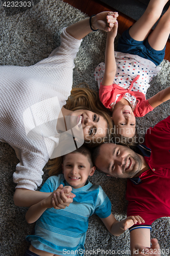 Image of happy family lying on the floor