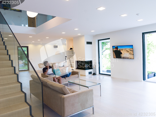 Image of young happy couple relaxes in the living room