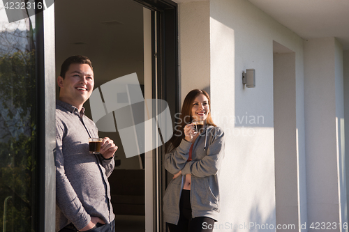Image of couple enjoying on the door of their luxury home villa