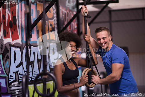 Image of Portrait of multiethnic couple  after workout at gym