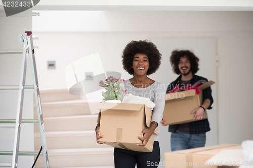 Image of multiethnic couple moving into a new home