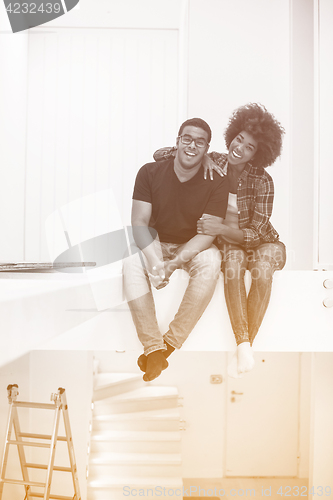 Image of couple having break during moving to new house