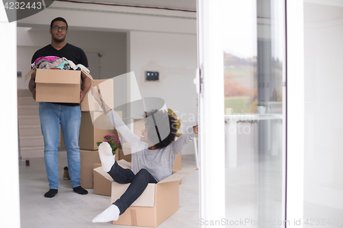 Image of African American couple  playing with packing material