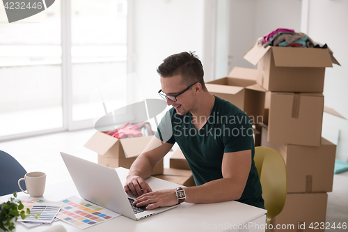 Image of Young man moving in a new home