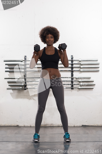 Image of black woman doing bicep curls