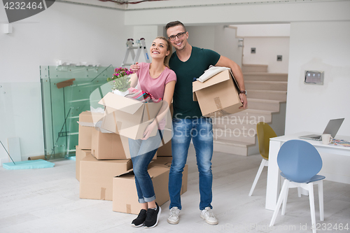 Image of young couple moving into a new home