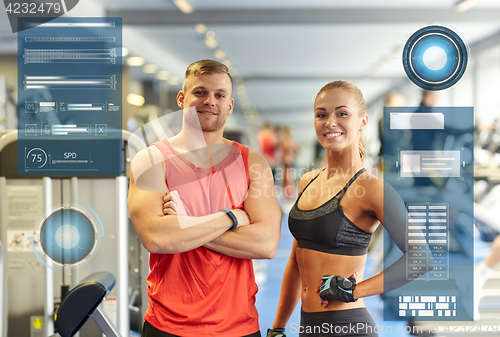 Image of smiling man and woman in gym