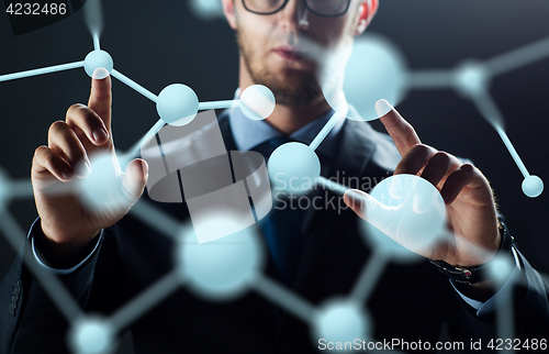 Image of close up of businessman touching virtual screen