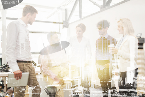 Image of happy business team drinking coffee at office