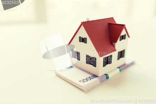 Image of close up of home or house model and money