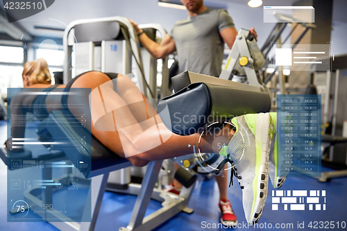 Image of man and woman flexing muscles on gym machine