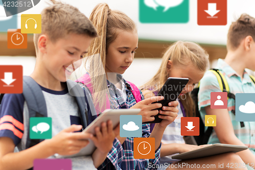 Image of happy elementary school students with tablet pc