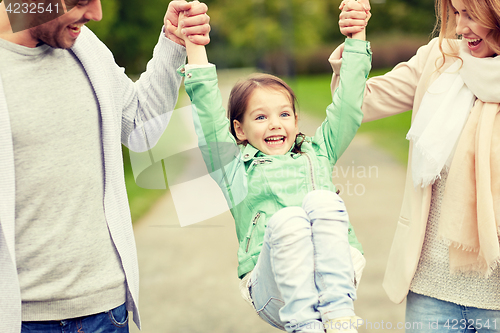 Image of happy family walking in summer park and having fun