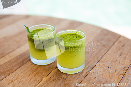 Image of two glasses with drinks or cocktails on bar table