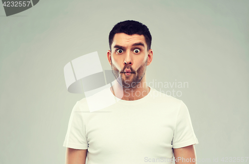Image of man with fish-face over gray background