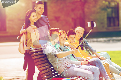 Image of happy teenage students taking selfie by smartphone