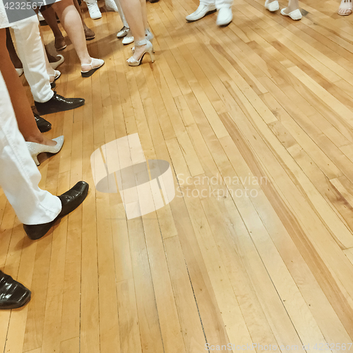 Image of People\'s feet on parquet floor