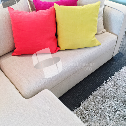 Image of Bright cushions on gray corner sofa