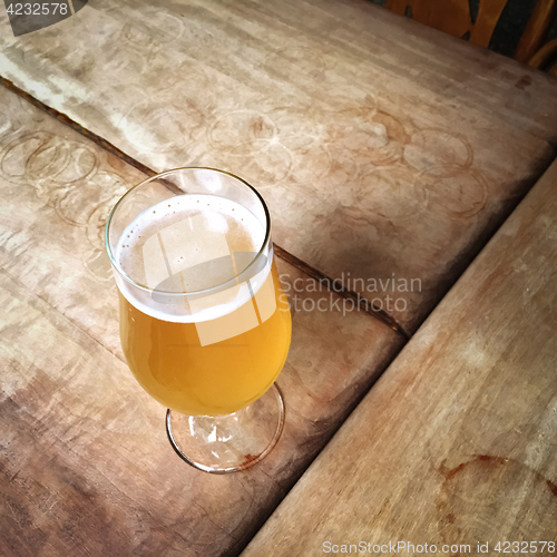 Image of Glass of unfiltered beer on a bar table