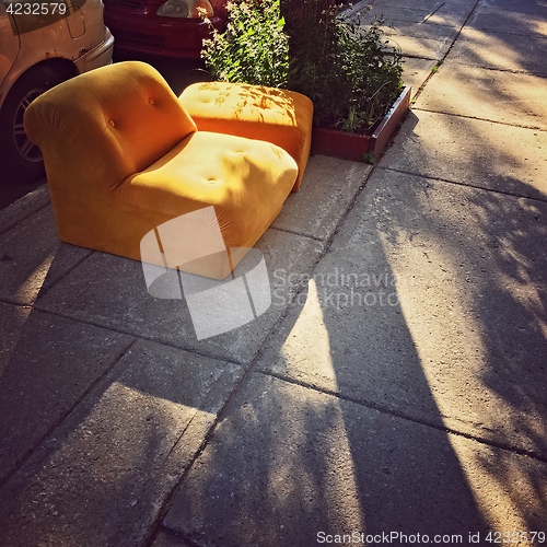 Image of Abandoned orange sofa on the street