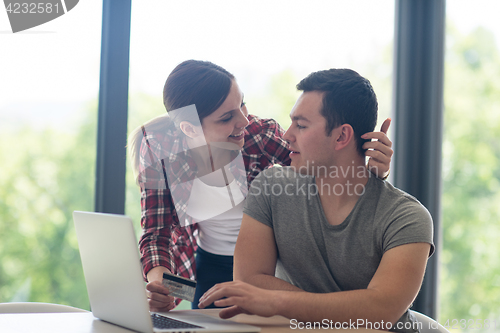 Image of happy young couple buying online