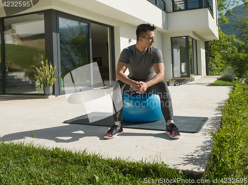 Image of man doing morning yoga exercises
