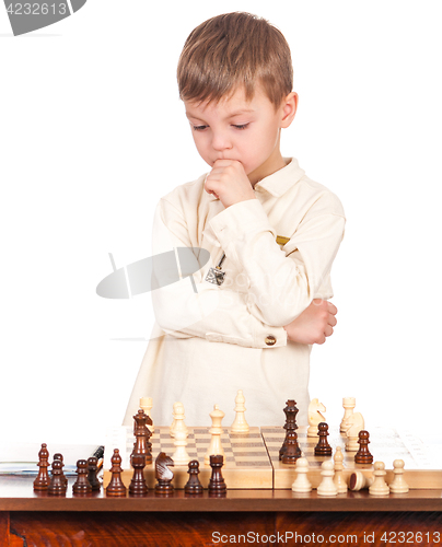 Image of Little boy with chessboard