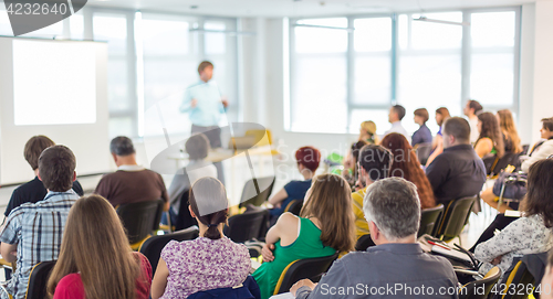 Image of Speaker giving presentation on business conference.