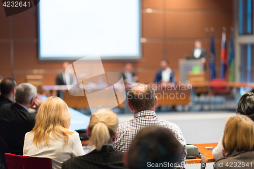 Image of Public speaker giving talk at business event.