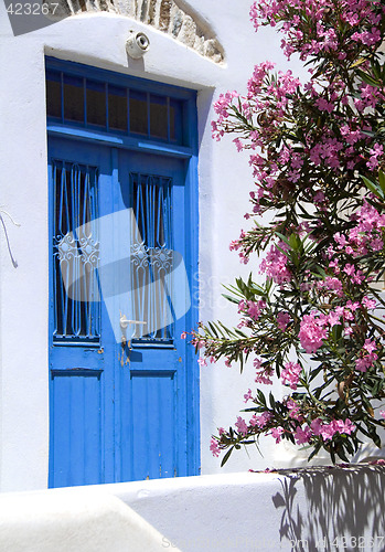 Image of greek island ancient building door with flowers