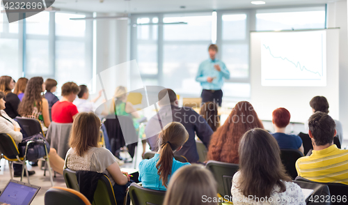 Image of Speaker giving presentation on business conference.