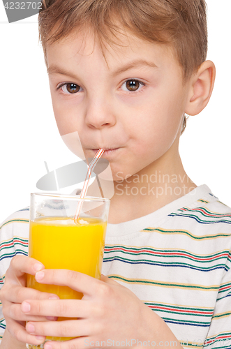 Image of Little boy drinking orange juice