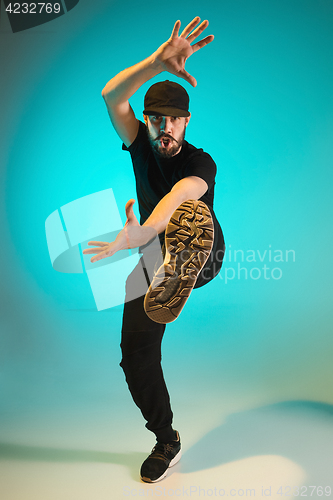 Image of The silhouette of one hip hop male break dancer dancing on colorful background