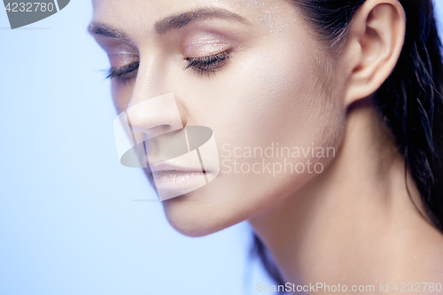 Image of Beautiful woman face portrait close up on blue