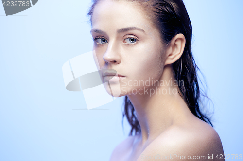 Image of Beautiful woman face portrait close up on blue