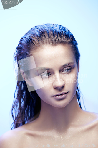Image of Beautiful woman face portrait close up on blue