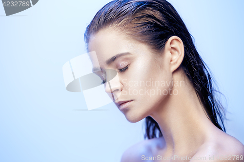 Image of Beautiful woman face portrait close up on blue
