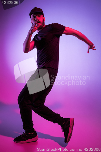 Image of The silhouette of one hip hop male break dancer dancing on colorful background