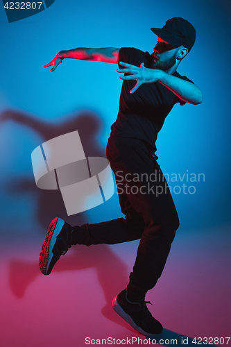 Image of The silhouette of one hip hop male break dancer dancing on colorful background