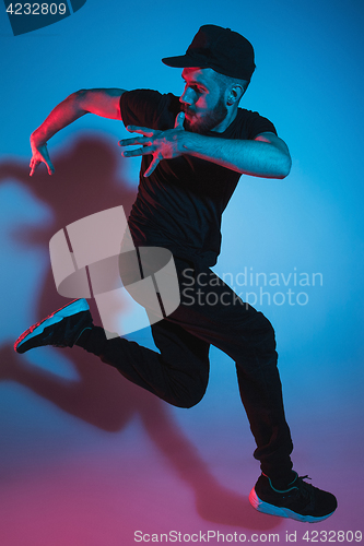 Image of The silhouette of one hip hop male break dancer dancing on colorful background