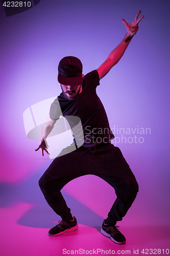 Image of The silhouette of one hip hop male break dancer dancing on colorful background