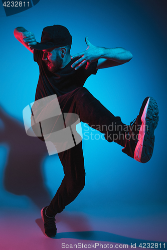 Image of The silhouette of one hip hop male break dancer dancing on colorful background