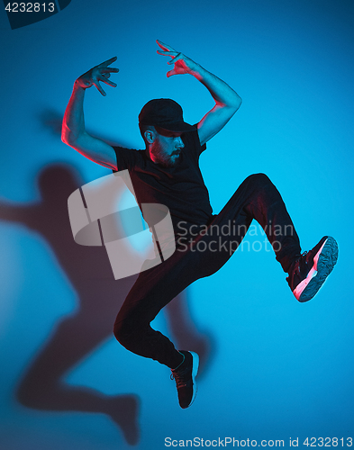 Image of The silhouette of one hip hop male break dancer dancing on colorful background