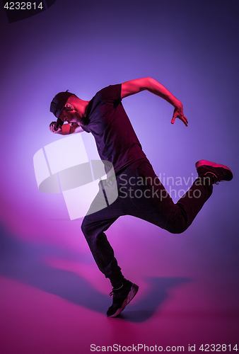 Image of The silhouette of one hip hop male break dancer dancing on colorful background