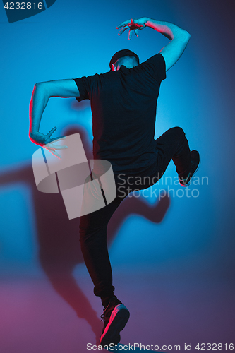 Image of The silhouette of one hip hop male break dancer dancing on colorful background