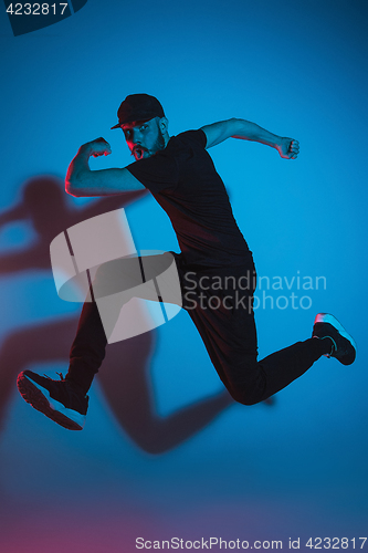 Image of The silhouette of one hip hop male break dancer dancing on colorful background