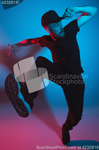 Image of The silhouette of one hip hop male break dancer dancing on colorful background